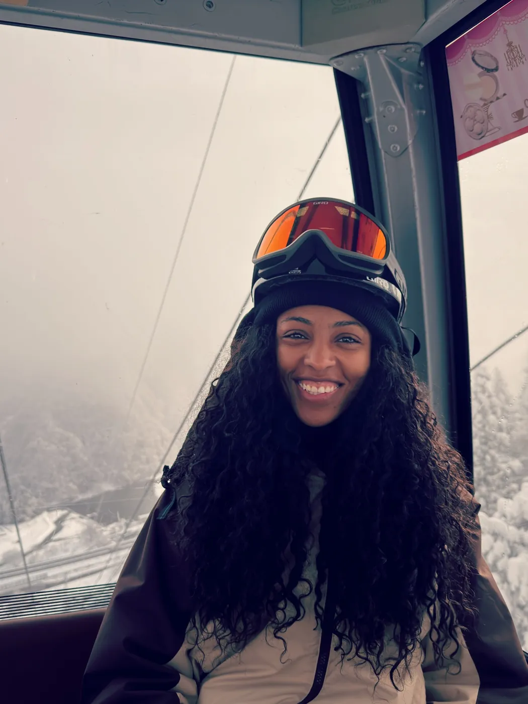 Kay smiling in a ski gondola in Japan